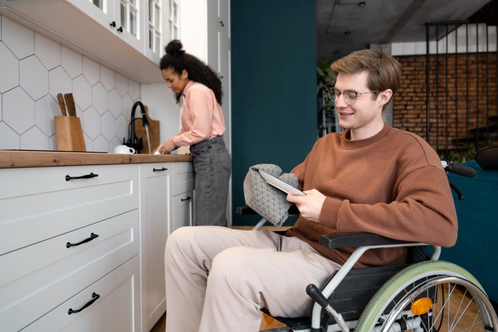 Support worker assisting an NDIS participant with daily tasks in a shared living home